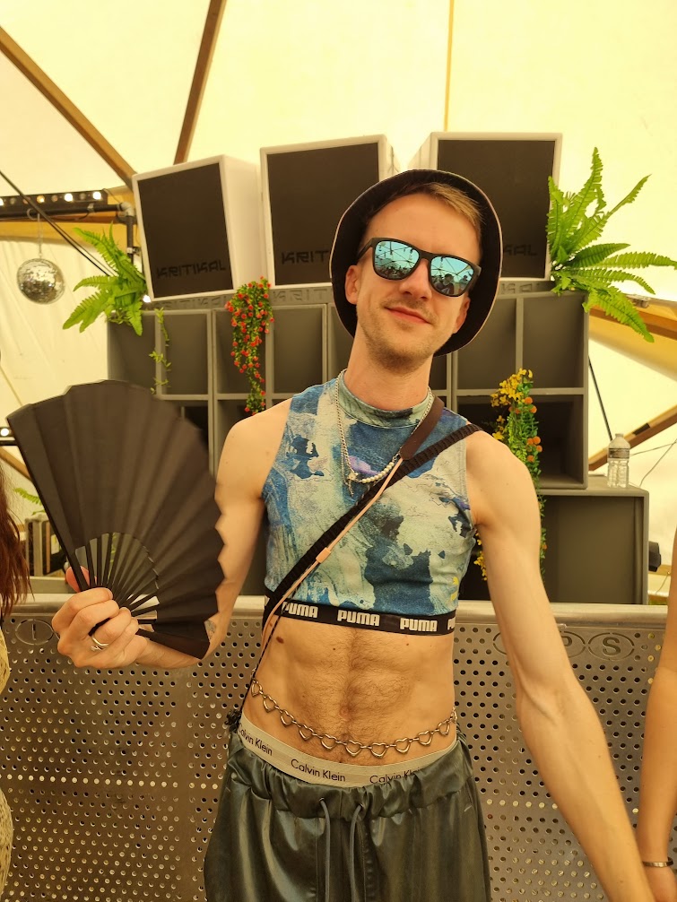 Lloyd dressed up at a festival, disco ball overhead